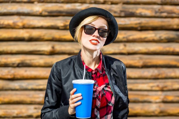 istock Happy young woman drinking outdoors 936625554