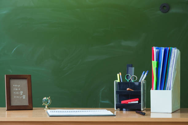 istock Education background with copy space. Student or teacher desk table on blackboard background. Classroom. Back to school. 936625616