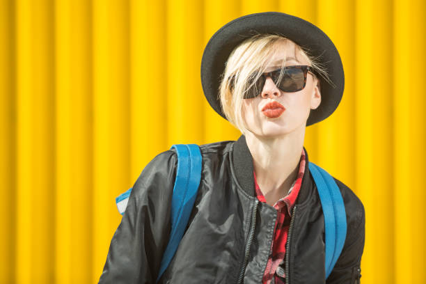 istock Happy young woman over bright yellow wall 936626162