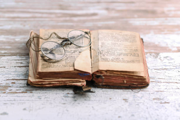 istock Ancient prayer book with old spectacles, Old Slavic language in the book 936626302