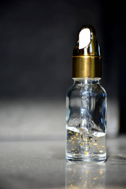 istock Luxurious facial serum container with dropper on black background 936626358