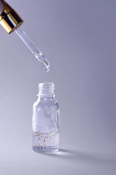 istock Luxurious facial serum container with dropper on ultra violet background 936626428