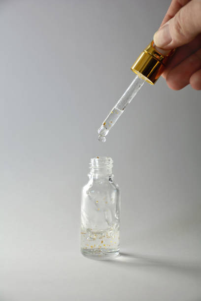 istock Luxurious facial serum container with dropper on gray background 936626452