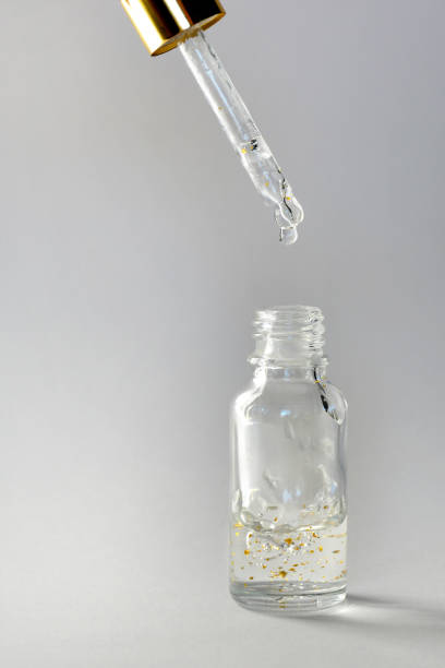 Luxurious facial serum container with dropper on white background