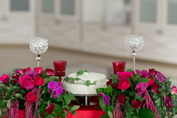istock White cake, flowers, crystal glasses on the red wedding table 936626784