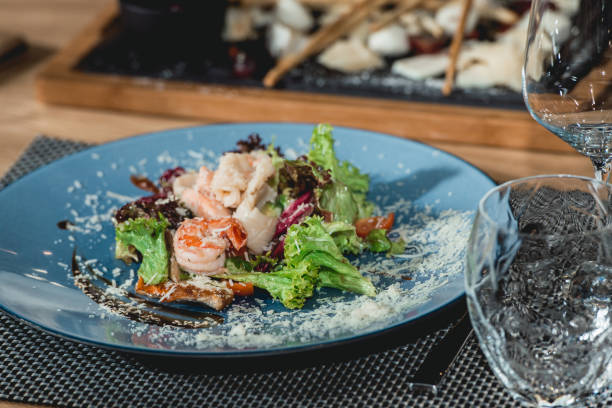 istock delicious salmon salad with shrimp and egg in a restaurant. small portion 936629370