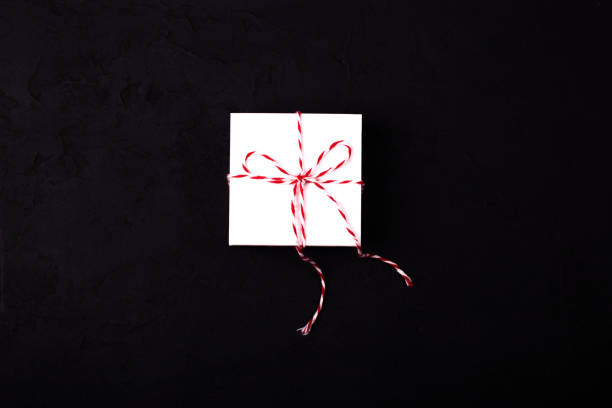 istock Gift birthday Christmas present concept - white gift box withribbon  on black background 936635514