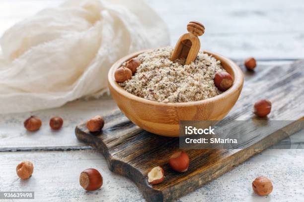 Hazelnut Flour In Wooden Bowl And Whole Hazelnut Stock Photo - Download Image Now - Backgrounds, Bowl, Brown