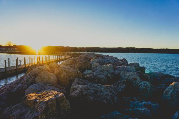 istock sunset over a rock jetty on lake michigan 936642256