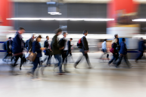Crowd of Motion Blurred Businesspeople Walking in Subway Station, London