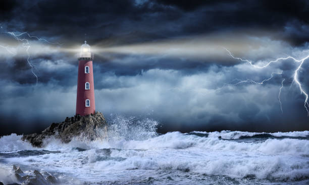 Lighthouse In Stormy Landscape - Leader And Vision Concept Lighthouse On Rock In Stormy Sea lighthouse photos stock pictures, royalty-free photos & images