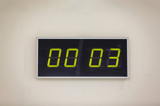 istock Black digital clock on a white background showing time hours minutes 936647298