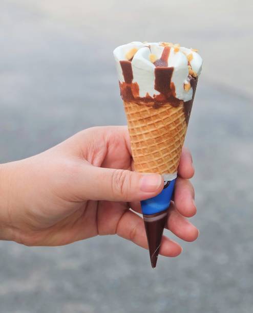 istock Hand Holding Ice Cream Cones with Chocolate 936650780