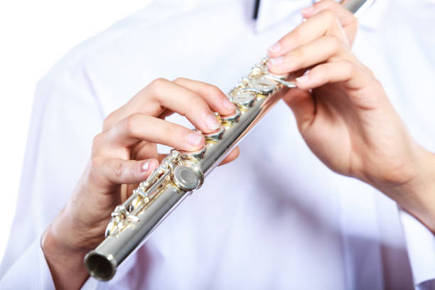 istock Hands of young man playing the flute 936653498