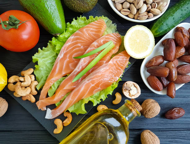 istock red fish, avocado on wood 936658258