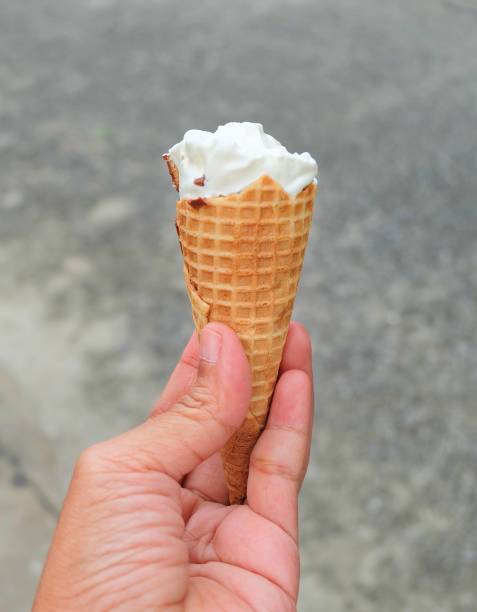 istock Hand Holding Ice Cream Cones with Chocolate 936658884