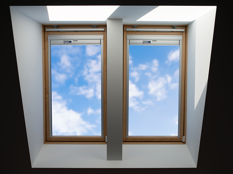 double roof windows overlooking the blue slightly cloudy sky