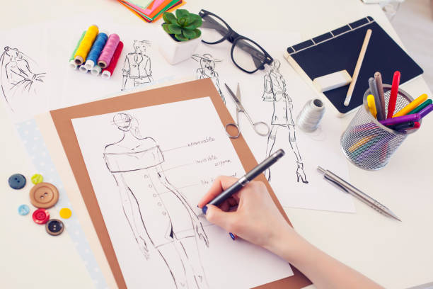 Fashion designer and sketches Fashion designer in work. Concept of small fashion studio. fashion designer photos stock pictures, royalty-free photos & images
