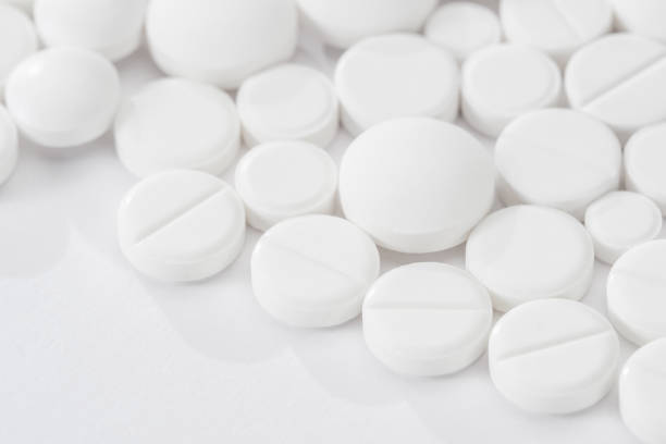 istock white pills and tablets capsule isolated on white background 936659526