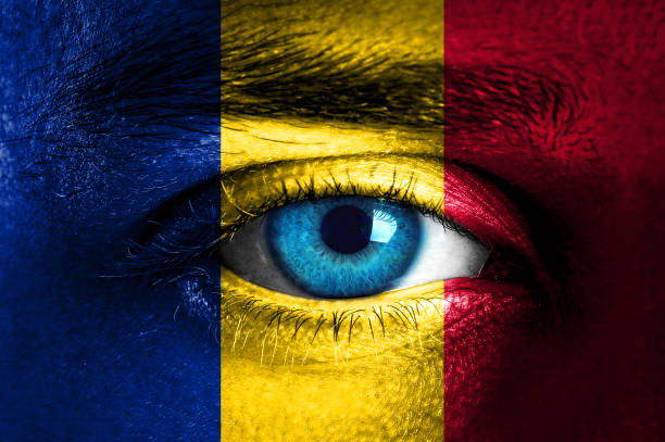 istock Human face painted with flag of Romania 936665642
