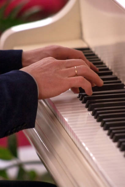 istock Pianist hands playing classical piano music. 936669860