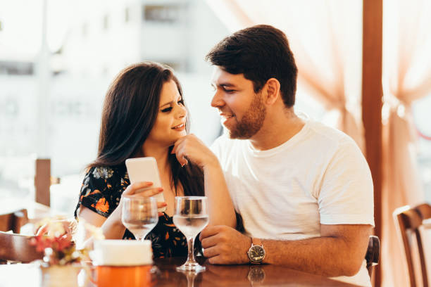 istock Couple at restaurant looking at his smart phone 936674436