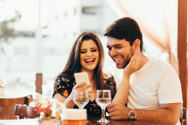 istock Couple at restaurant looking at his smart phone 936674438