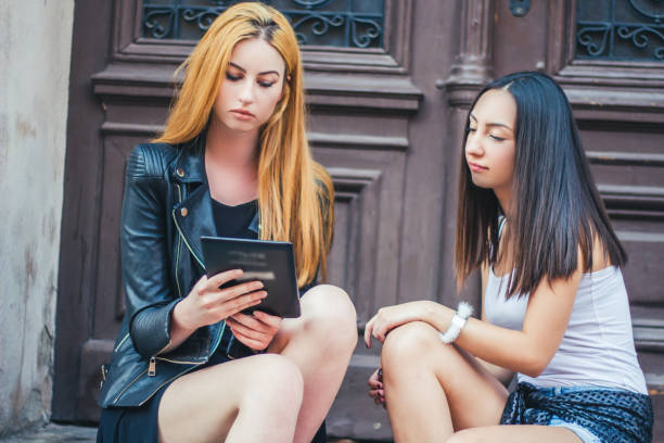 istock Two young woman looking at tablet. 936674506