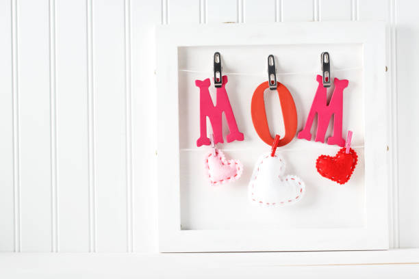 istock Red and pink Mom letters hanging 936674940