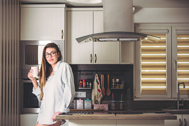 istock Young Woman Enjoying Her Morning Coffee In The Kitchen 936675456