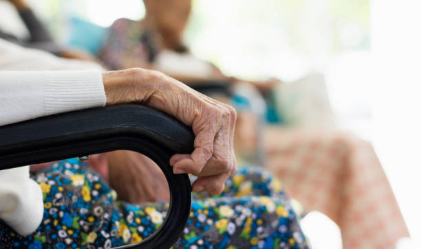 istock Close-up elderly wrinkle skin hand, elderly sit on wheelchair 936681554