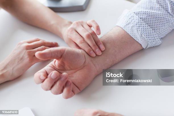 Measuring Of Pulse On Wrist By The Doctor Stock Photo - Download Image Now - Taking Pulse, Wrist, Examining