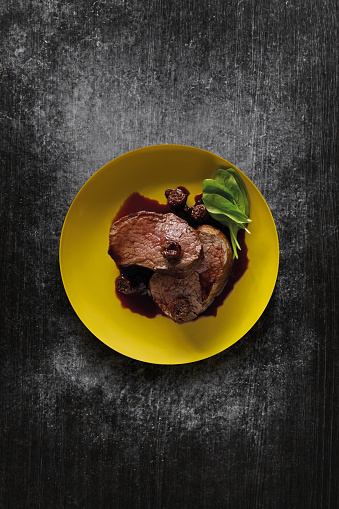 Steak dish plate on dark background