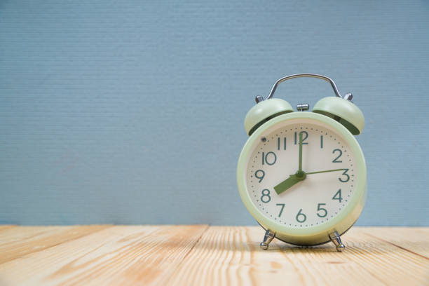istock Retro vintage alarm clock on wood table, time concept. 936689398