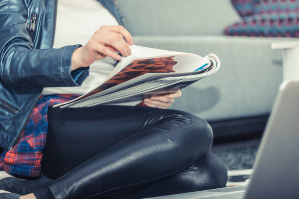 istock Unrecognizable woman reading magazine. 936693078