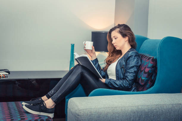 istock Cup of coffee and good book is all she needs. 936693904