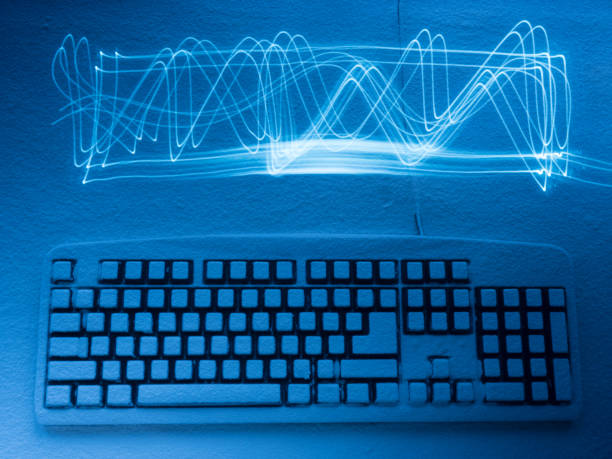 istock computer keyboard covered with snow illuminated by blue light with traces from light graphic 936693928