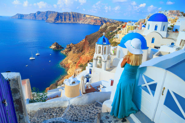Blond woman looking at view in Santorini Discovering Greece.Beautiful blond woman enjoying vacations in Santorini, Greece. Looking at view. fira santorini stock pictures, royalty-free photos & images