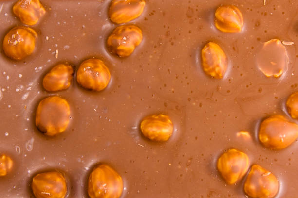 istock Background of the dark chocolate with a hazelnuts 936697640