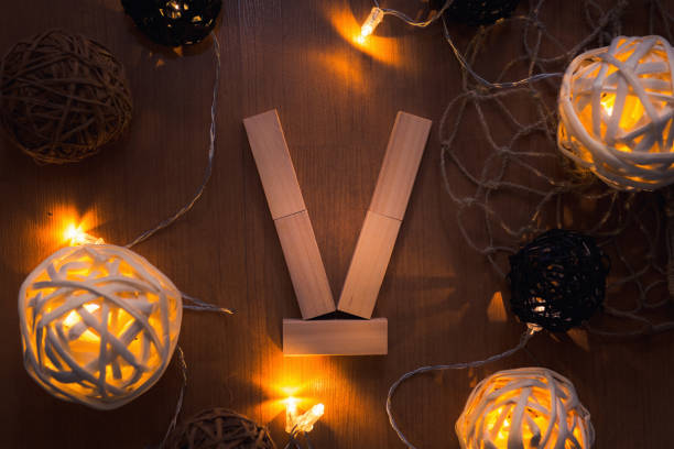 istock Alphabet dominoes and decorative lights background 936729270