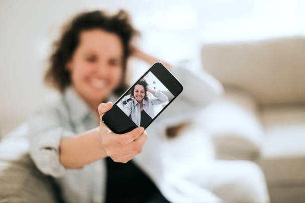istock Young women doing selfie on sofa 936738602