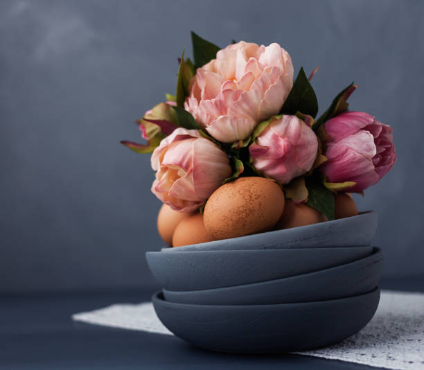 istock Organic free range eggs in a stack of gray ombre bowls with flowers 936738678
