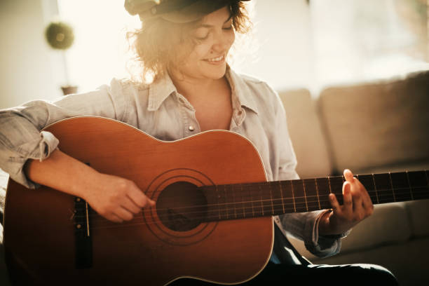 istock Young guitarist practising at home 936738912