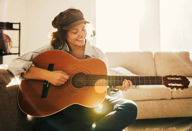istock Young guitarist practising at home 936739136