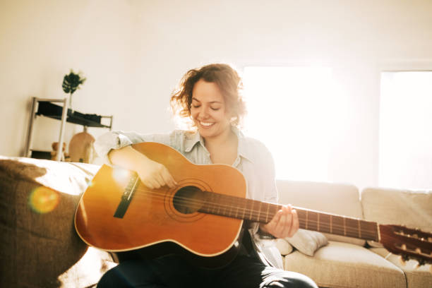 istock Young guitarist practising at home 936739238