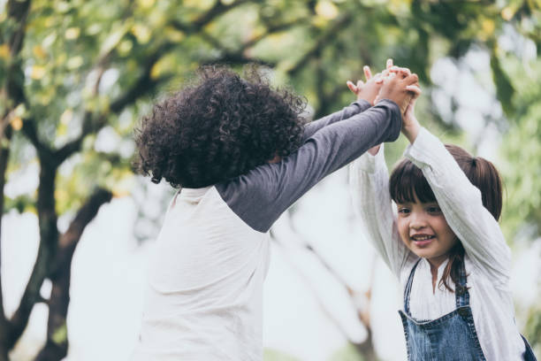 istock Little boy and girl playing together in a park 936746302