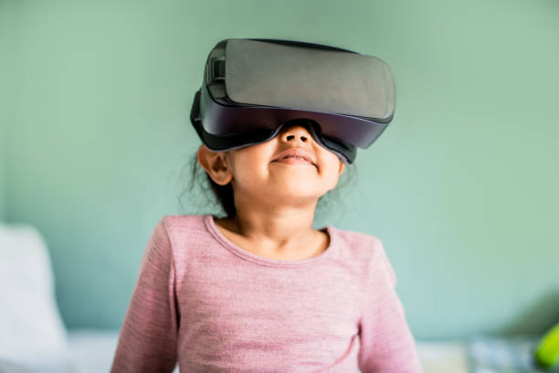 istock Girl wearing virtual reality headset at home 936749448