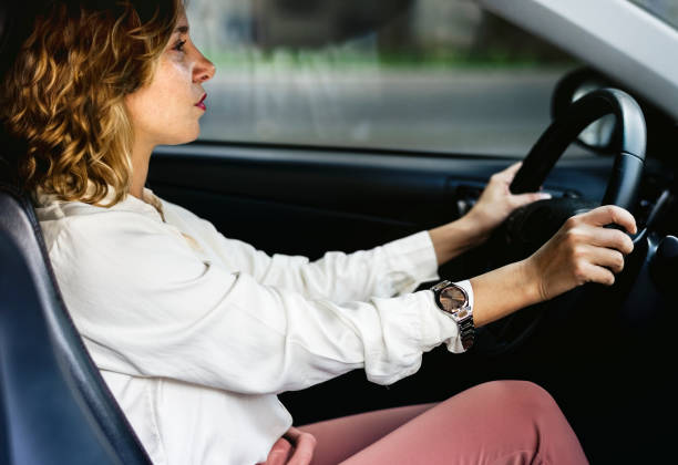 istock Woman driving a car on a road 936749458