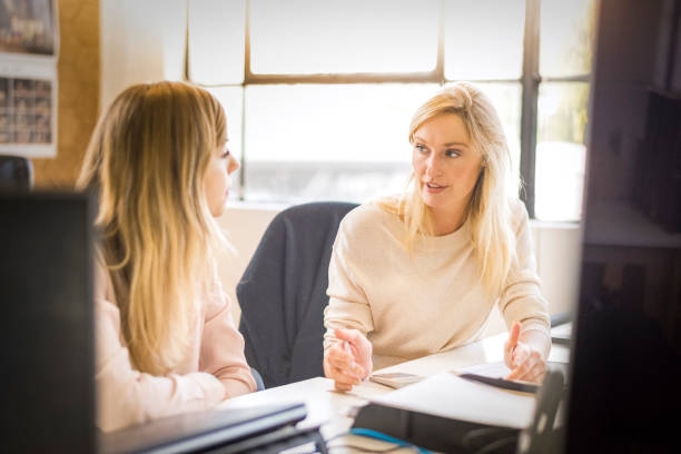 istock Businesswomen discussing at desk in office 936753380