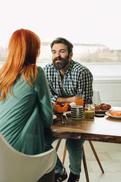 istock Young couple enjoying in their meal while talking to each other. 936756420